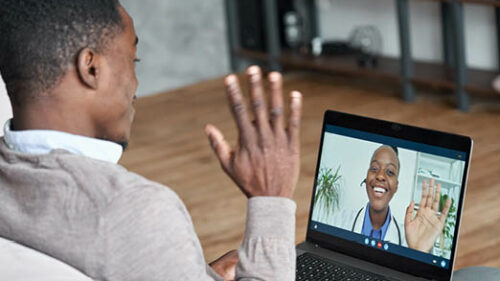 A man talking to a doctor on a computer screen