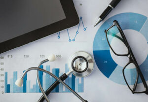 healthcare equipment on a desk with graphs and glasses