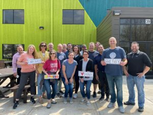 A group of CSDZ employees celebrating being part of the Holmes Murphy enterprise and their 90th anniversary through volunteering.
