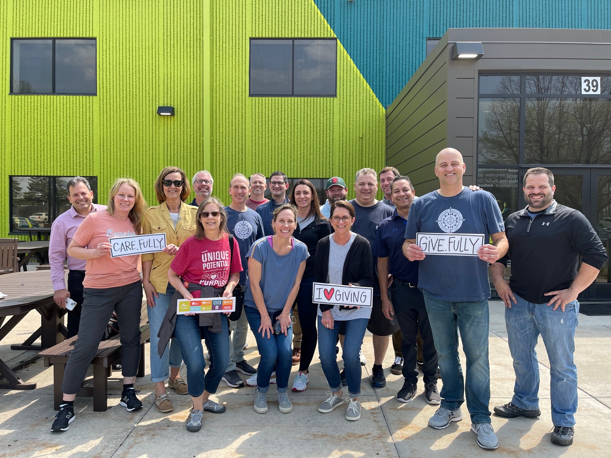 A group of CSDZ employees celebrating being part of the Holmes Murphy enterprise and their 90th anniversary through volunteering.