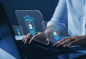A man typing on a laptop keyboard and a symbol of a lock appears