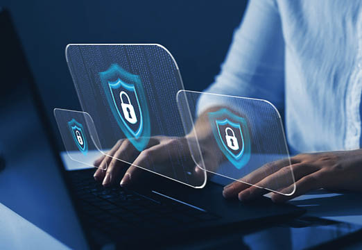 A man typing on a laptop keyboard and a symbol of a lock appears