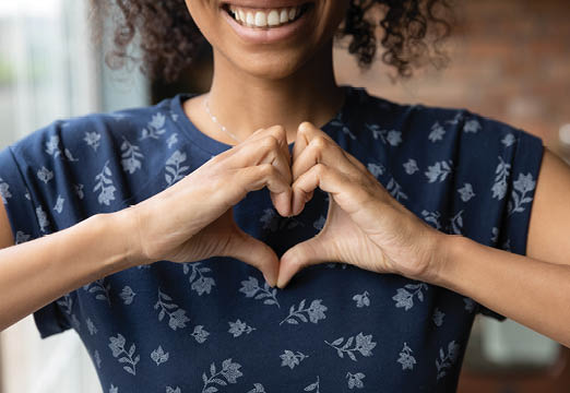A woman making a heart with her hands