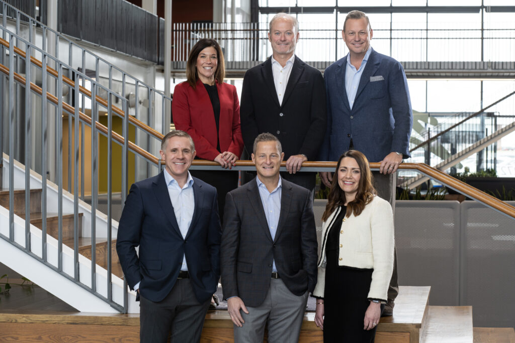 The 2023 leadership team standing in the Holmes Murphy headquarters.