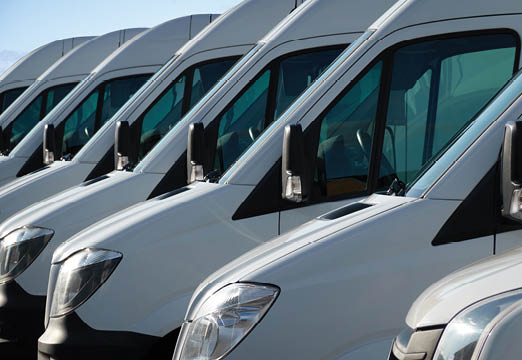 A line of parked commercial vans