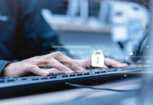 A professional typing on the computer with a lock