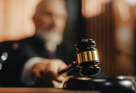 A judge banging his gavel in court