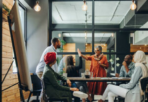 A group of diverse employees in age and race meeting together.