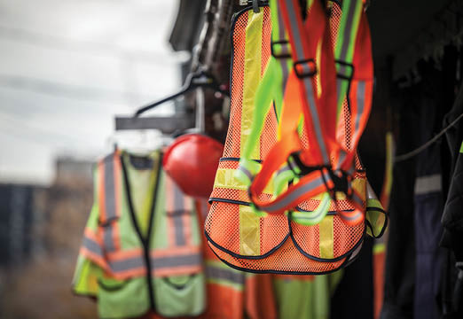 Construction safety vests hanging on a job site