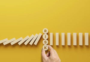 A yellow background with wooden blocks and the word Risk.