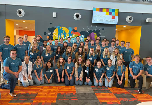 A large group of college students wearing Give.Fully. t-shirts in the Holmes Murphy headquarters.