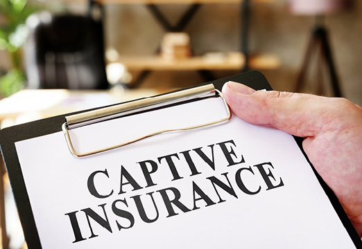A clip board with Captive Insurance paperwork
