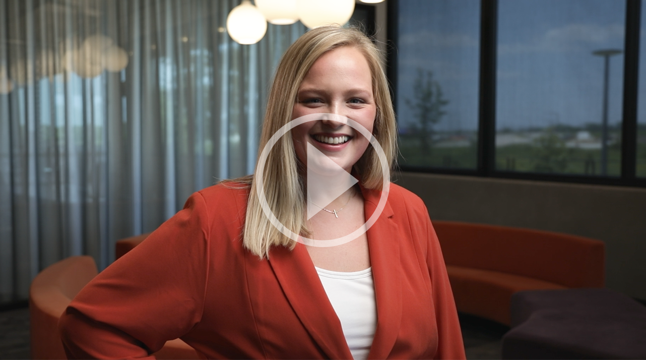 A video thumbnail of Rilley Ring-Foss, a white woman in an orange blazer.