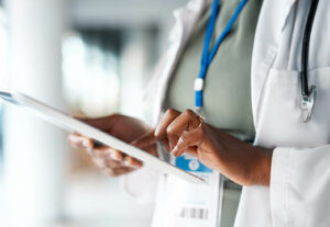 A doctor checking her tablet.