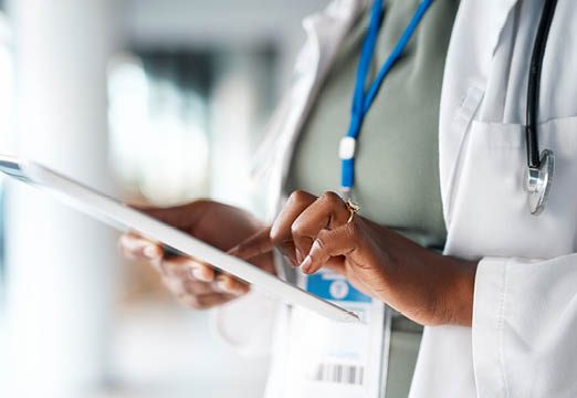 A doctor checking her tablet.