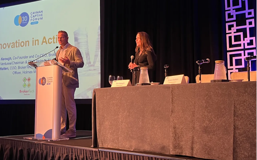 Susan Hatten and Dan Keough speaking on stage.