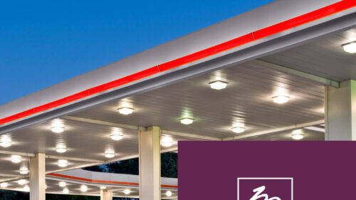 The bright lights of a gas station pumps. Holmes Murphy Petroleum Distributors & Retailors logo.