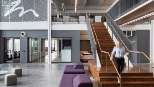 Employee on staircase in Holmes Murphy atrium