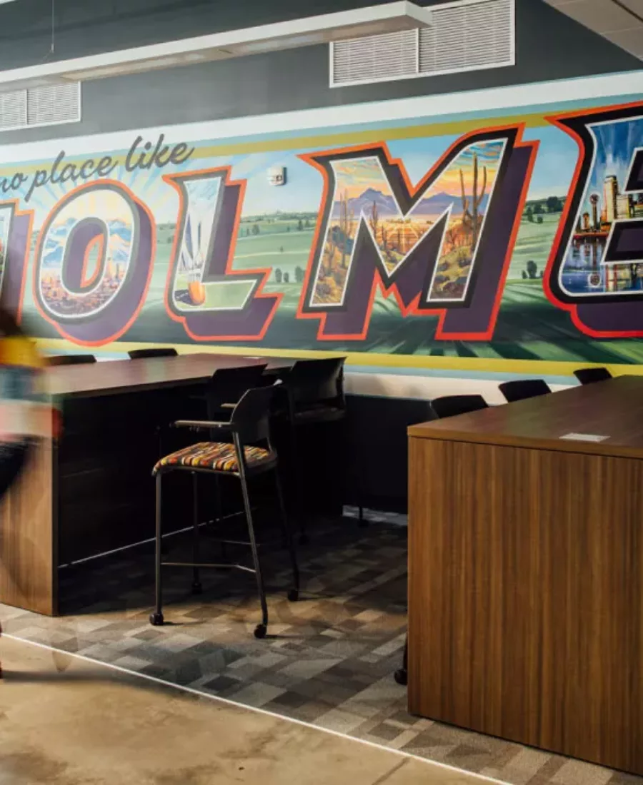 There's no place like Holmes mural featuring various office locations in each letter of H-O-L-M-E-S