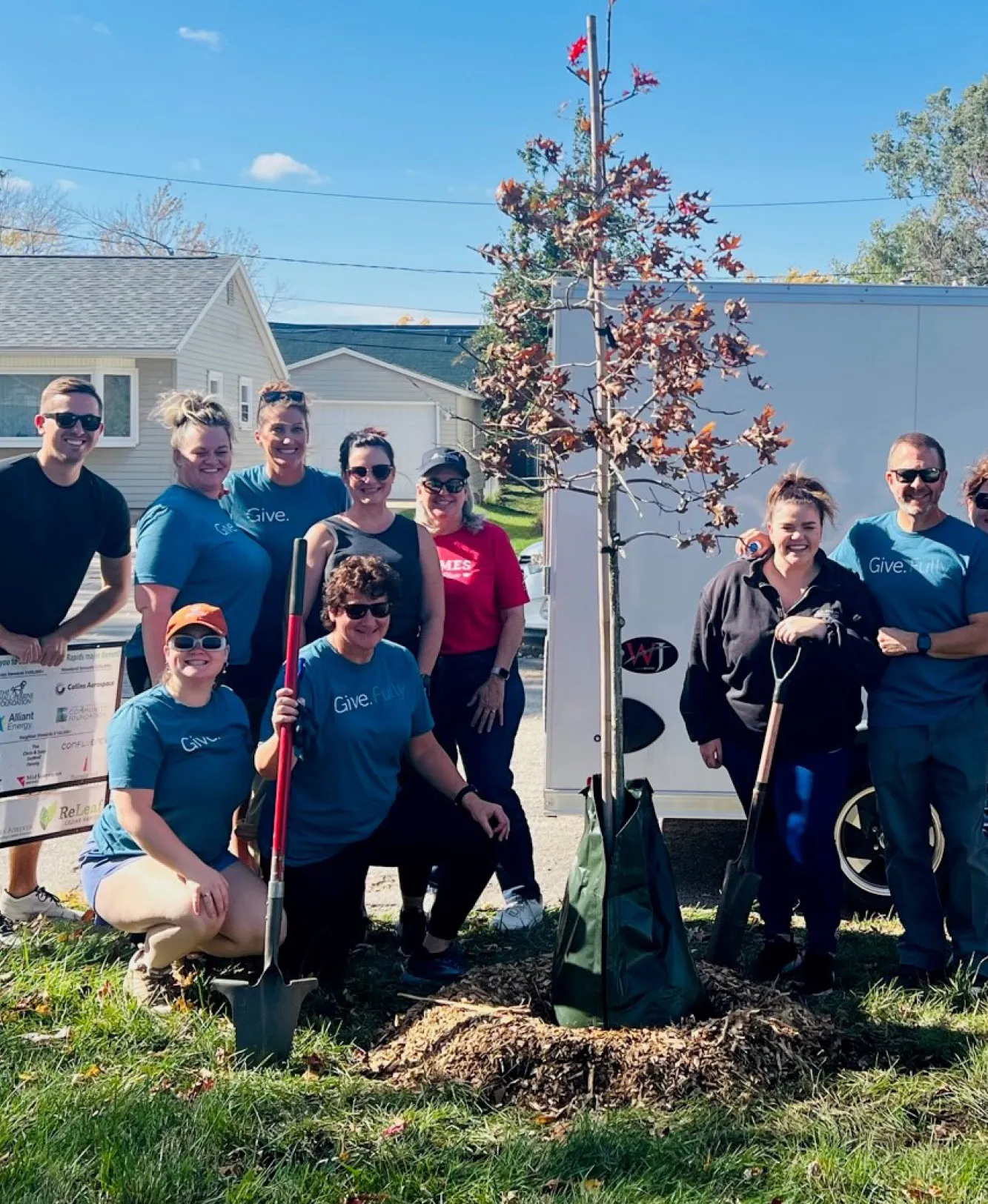 A group of Holmes Murphy employees planting trees.