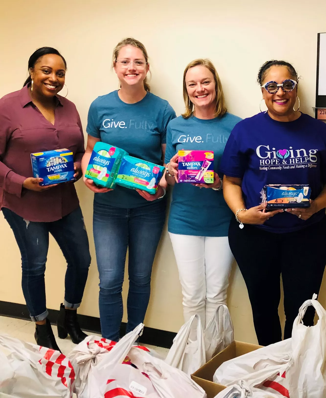 Holmes Murphy employees delivering menstrual products to a charity