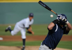 Baseball players swinging a baseball bat.