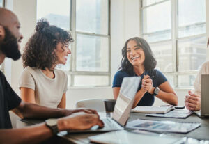 Three business professionals at a conference table.