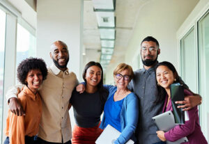 A group of diverse employees smiling for a picture.