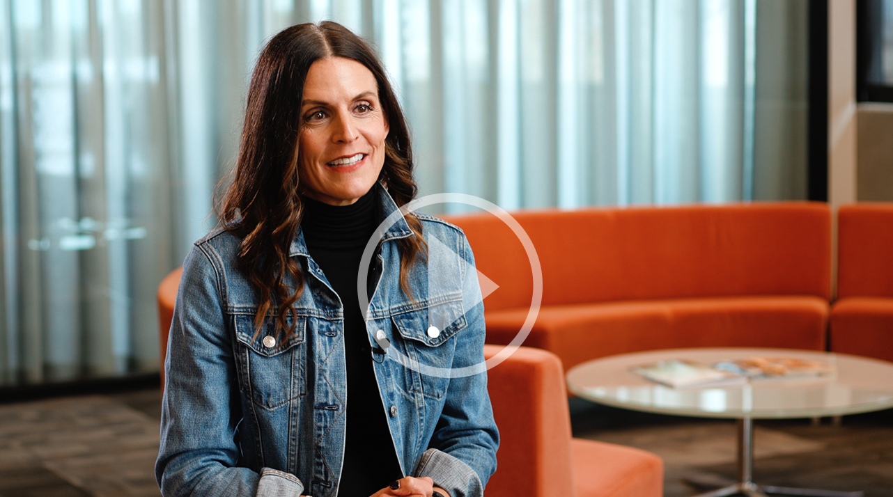 Stephanie Leuck in a denim jacket and professional clothes in an office.