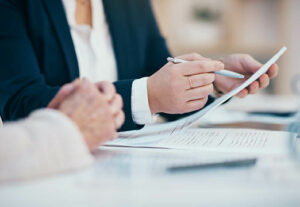 Two business professionals discussing a contract.