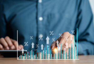 A professional with a visual chart with arrows going up.