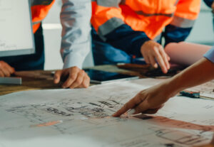 AEC collaborating over a blueprint