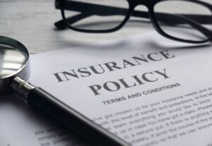 Insurance Policy paperwork on a desk.