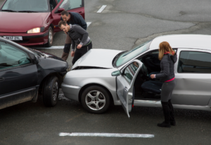 two cars hit each other and the drivers are talking