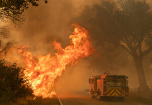A fire truck driving to a fire