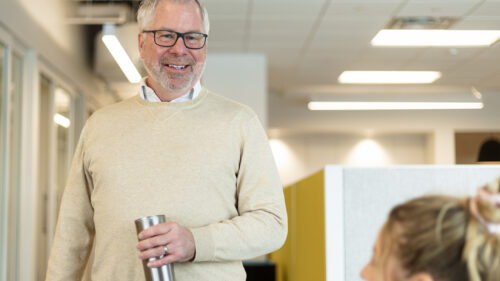 A Holmes Murphy employee talking with another employee.