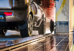 A car driving through a wash system