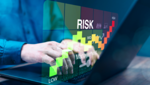 A risk graph appears as a person types on a laptop