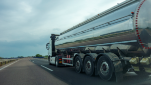 A hazmat truck drives down a highway.
