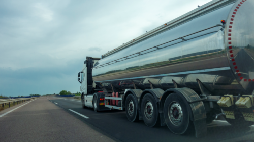 A hazmat truck drives down a highway.