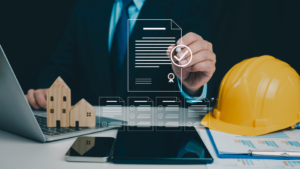 A person taps a pen on a digital contract above a desk with a hard hat.
