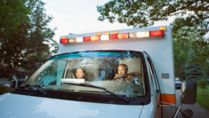 EMS staff sit attentively in the ambulance cab.