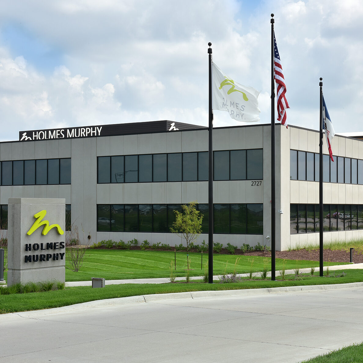 holmes murphy building with sign and flags