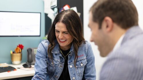 Two employees laughing at the Holmes Murphy Cedar Rapids office