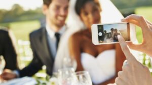 A newlywed couple poses for a phone photo