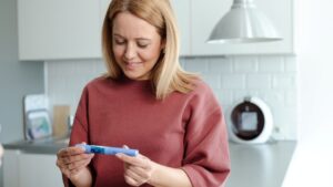 A woman looks at a GLP-1 medication