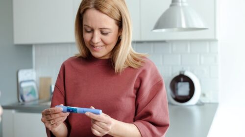 A woman looks at a GLP-1 medication