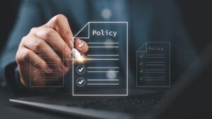 A person uses a stylus to tap a digital policy document