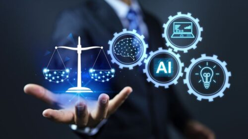 A blue image of a pixelated scale, brain, laptop, lightbulb, and AI hovers over the hand of a person in a suit.