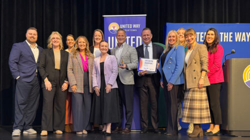 group of Holmes Murphy employees on stage accepting United Way award
